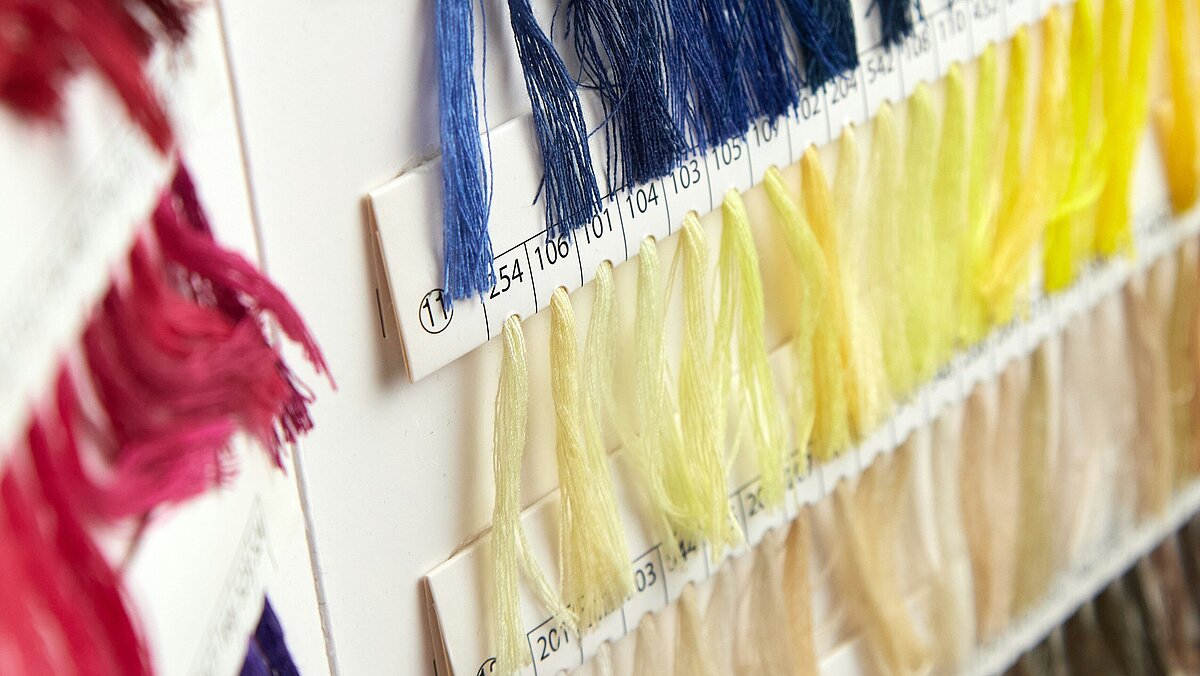 Colourful threads made from recycled Polyocean embroidery thread showcasing colour variety on a white background