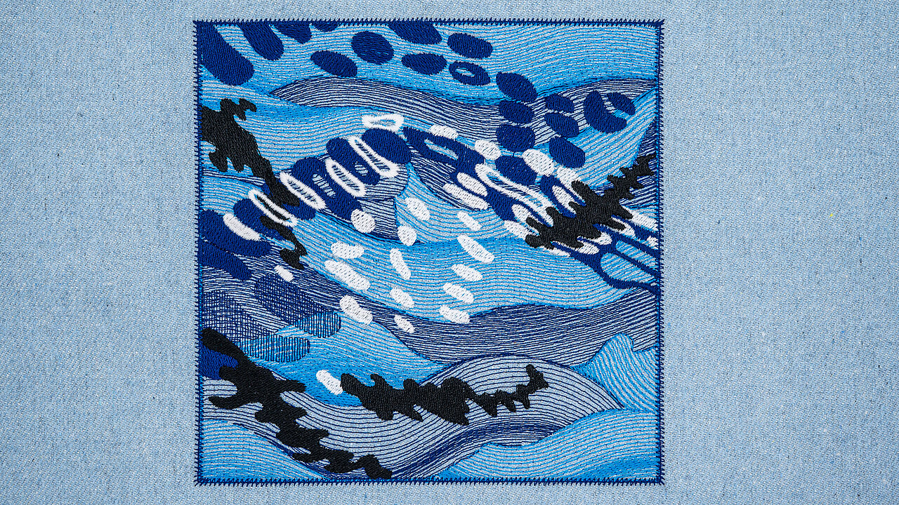 Abstract wave embroidery made with recycled Polyocean thread