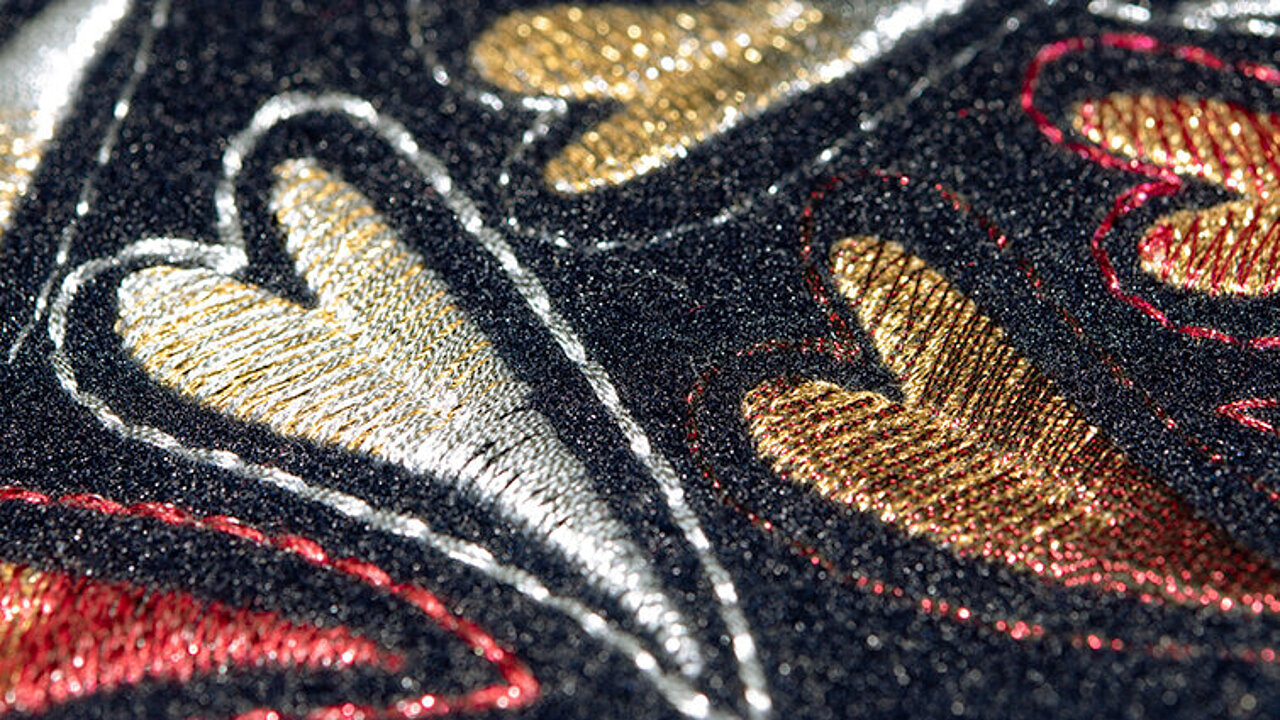 hearts embroidered with gold, silver and red metallic thread