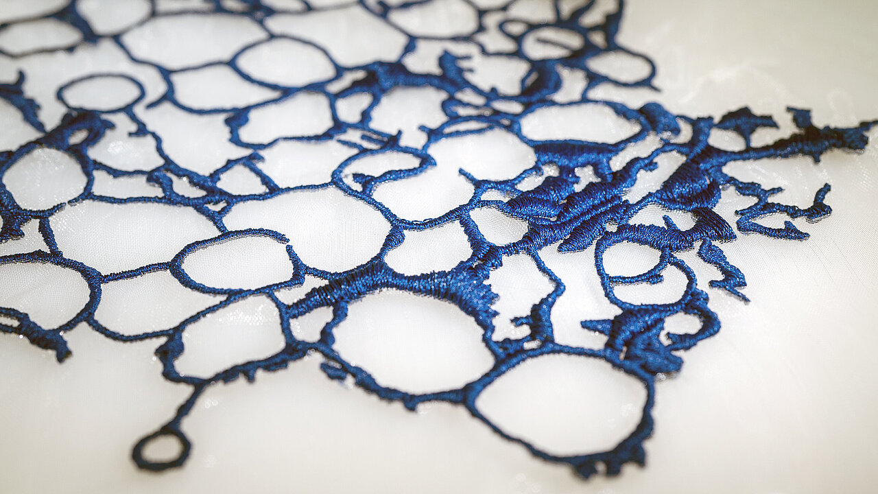 Modern abstract embroidery in dark blue made with Polyocean thread