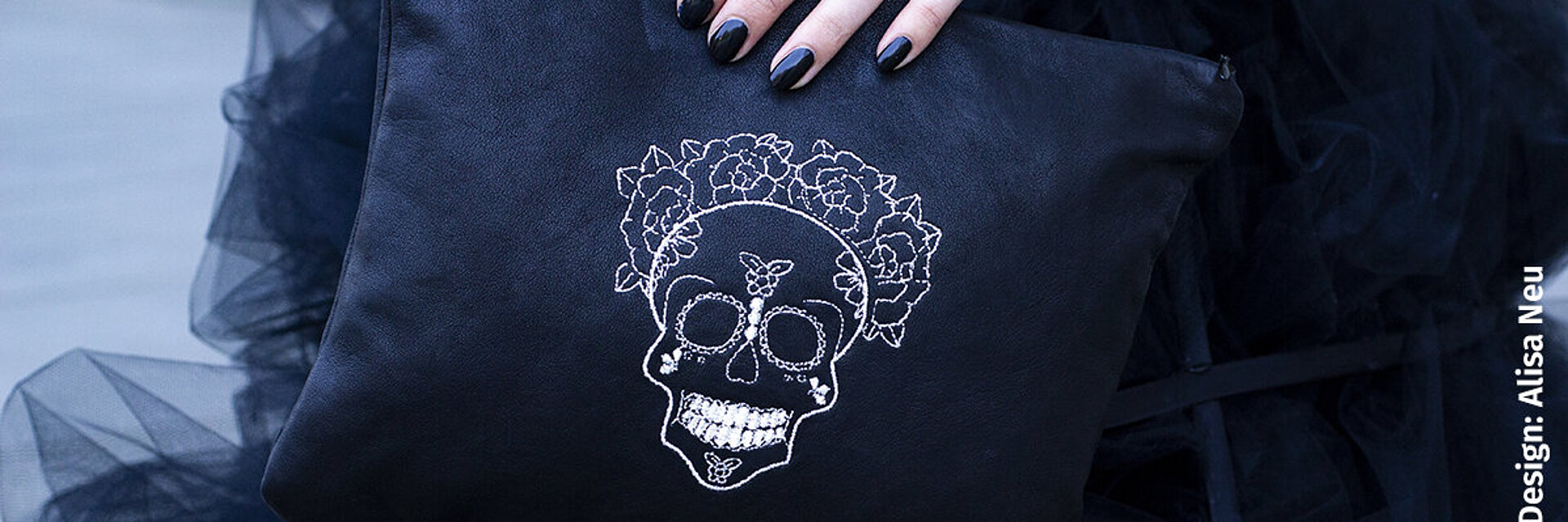 Bag with silver skull embroidery