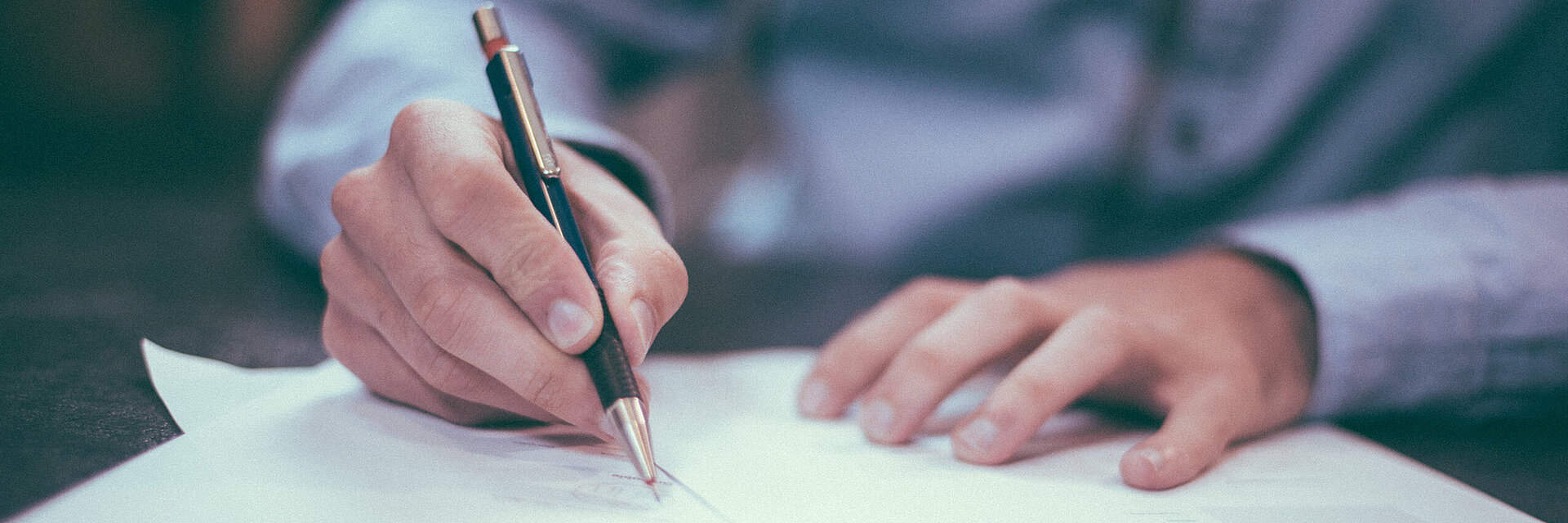Businessman writing on a paper