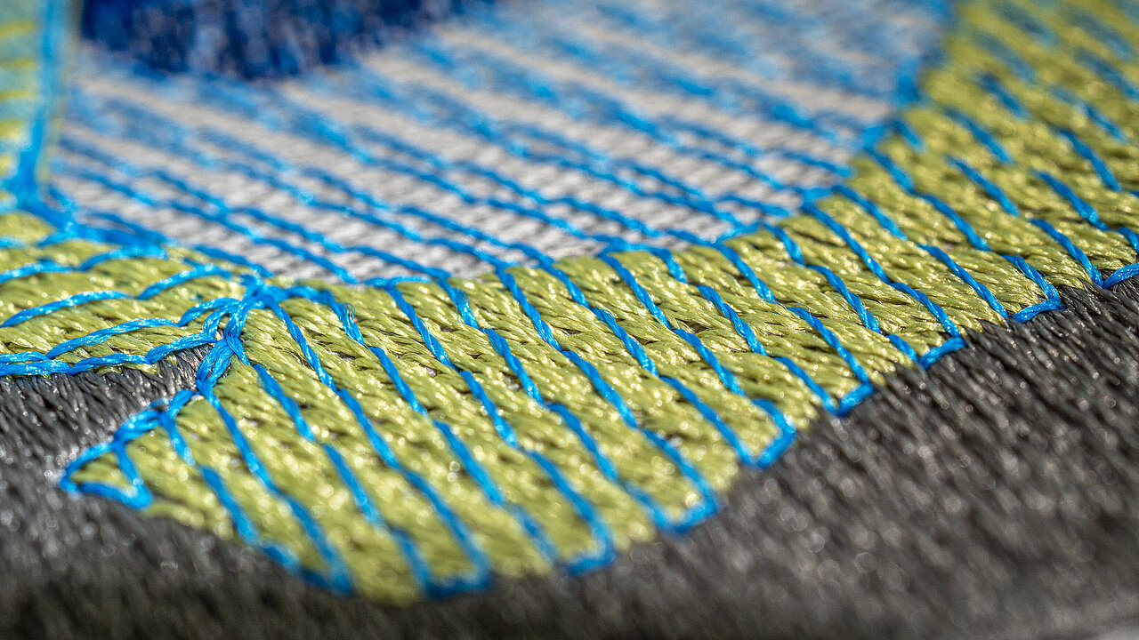 Close-up embroidery with Polyocean thread in green, blue and white