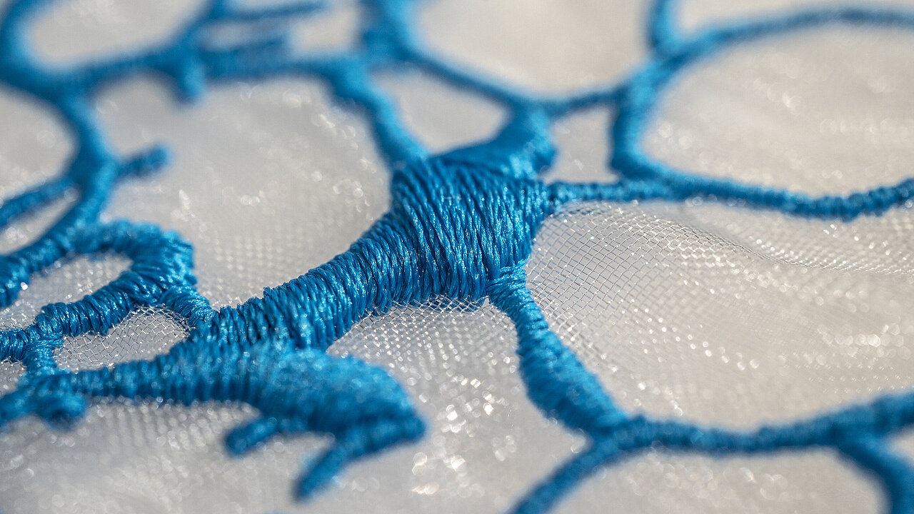 Close-up of blue embroidery made with sustainable Polyocean thread