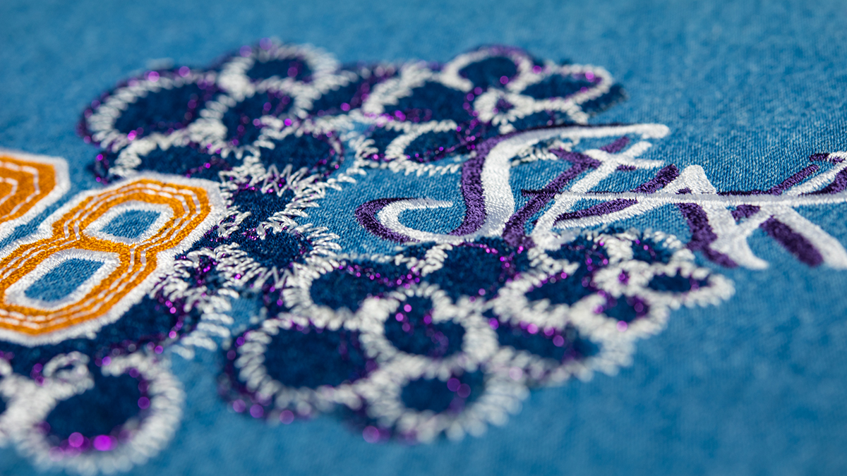 Voluminous embroidery on blue fabric